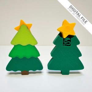 May include: Two wooden Christmas tree ornaments. One is assembled with a yellow star on top, and the other is disassembled. The trees are green with a brown trunk, and the star is yellow. The text "DIGITAL FILE FOR 3D PRINTING" is in the upper right corner.