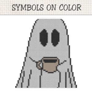 Op de afbeelding: Een kruissteekpatroon getiteld SYMBOLS ON COLOR met een spookvorm gevuld met zwarte ruitvormige symbolen en het cijfer 1. Het spook houdt een bruine koffiemok vast gevuld met het cijfer 7 tegen een witte achtergrond met een rasterpatroon.