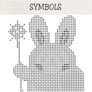 以下が含まれることがあります： 上部に「SYMBOLS」とラベル付けされたクロスステッチのパターンチャート。星型の杖を持ったウサギの白黒グラフィックが描かれています。デザインは、ひし形、ハート、ジグザグ線など、さまざまな幾何学模様の記号で構成されています。