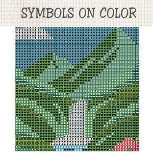 Pu&ograve; includere: Uno schema a punto croce intitolato SYMBOLS ON COLOR che presenta un design paesaggistico basato su griglia. L'immagine mostra una catena montuosa, una cascata centrale e un cielo blu, il tutto reso con vari simboli geometrici in verde e blu.