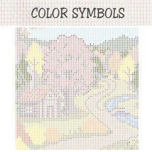 May include: A cross-stitch pattern chart titled COLOR SYMBOLS featuring a grid on white fabric. The design displays a dense arrangement of alphanumeric characters and symbols in various colors, including red, yellow, green, blue, and black.