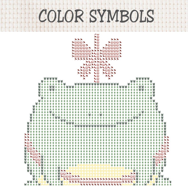 May include: A cross-stitch pattern chart titled COLOR SYMBOLS featuring a grid design of a frog with a butterfly on its head. The frog is composed of light green diamond symbols, while the butterfly uses red square and umbrella icons.