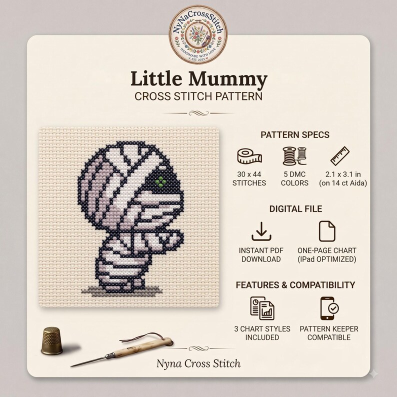 May include: A Little Mummy cross stitch pattern featuring a stitched mummy character on beige fabric. The digital file includes 30 x 44 stitches, 5 DMC colors, and measures 2.1 x 3.1 inches on 14 ct Aida. Includes a thimble and needle tool.