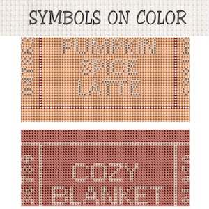 May include: A cross stitch pattern chart titled SYMBOLS ON COLOR featuring two sections. The top section has orange pumpkin icons with the text PUMPKIN SPICE LATTE. The bottom section has dark red leaf icons with the text COZY BLANKET.