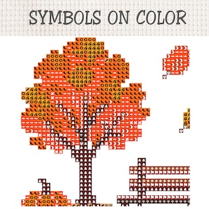 May include: A cross-stitch pattern titled SYMBOLS ON COLOR featuring a pixelated orange tree with a brown trunk, a pumpkin, a fence, and a falling leaf. The design uses various black symbols overlaid on orange and brown blocks to indicate thread colors.