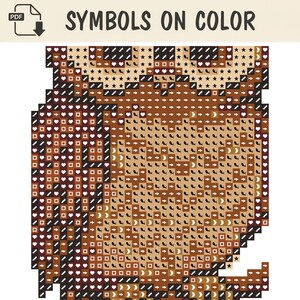 May include: A digital cross-stitch pattern titled SYMBOLS ON COLOR featuring a grid of brown and tan squares. Each square contains a unique white symbol, including arrows, hearts, stars, crescents, and geometric shapes, arranged to form an owl image.