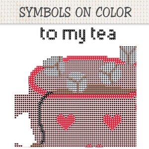 May include: A cross-stitch pattern featuring the text SYMBOLS ON COLOR and to my tea. The design displays a pixelated mug in shades of pink and red, decorated with two red heart shapes and filled with a beverage containing white foam elements.