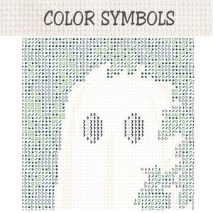 May include: A cross stitch pattern chart titled COLOR SYMBOLS featuring a grid of dark green and black geometric icons including triangles, squares, and circles. The central area is blank, forming the silhouette of a ghost with two dark eyes.