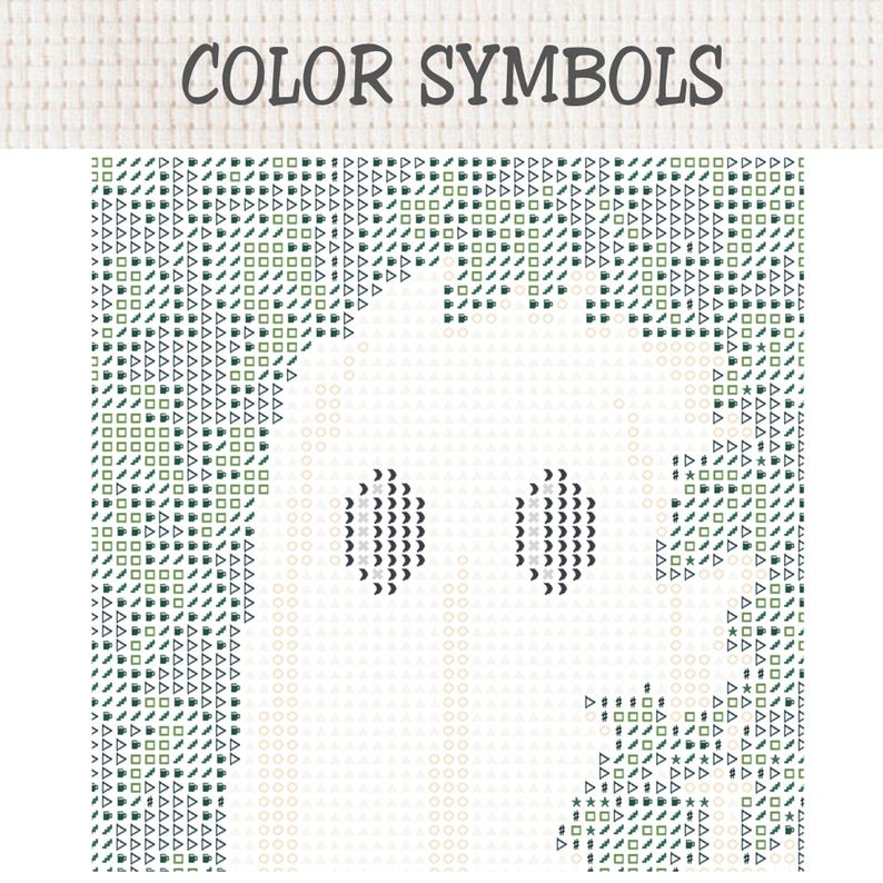 May include: A cross stitch pattern chart titled COLOR SYMBOLS featuring a grid of dark green and black geometric icons including triangles, squares, and circles. The central area is blank, forming the silhouette of a ghost with two dark eyes.