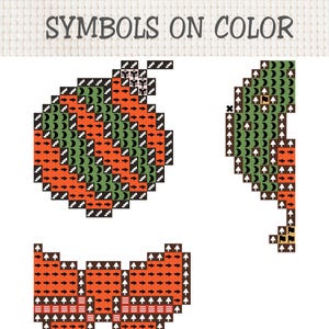 May include: A cross stitch pattern chart titled SYMBOLS ON COLOR featuring three distinct pixelated designs. The graphics include a round ornament, a curved shape, and a bow, all rendered in orange and green blocks with black symbols.