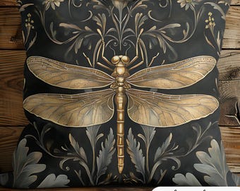 May include: A black cushion with a gold dragonfly and floral pattern. The cushion features a decorative, ornate design with a vintage aesthetic.