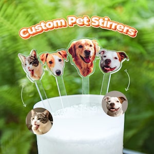 May include: Four clear acrylic drink stirrers featuring custom printed pet faces, including a cat and three dogs. The text Custom Pet Stirrers is displayed in an orange and white font above the stirrers, which are placed in a white cup.
