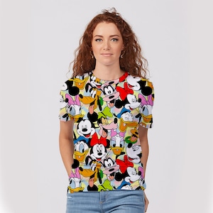May include: A white t-shirt with a colorful print of various Disney characters, including Mickey Mouse, Minnie Mouse, Donald Duck, Goofy, and Pluto.