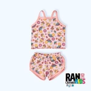 May include: A pink two-piece outfit for kids featuring a sleeveless tank top and shorts. Both pieces have a colourful print of rainbows, smiley faces, and mushrooms.