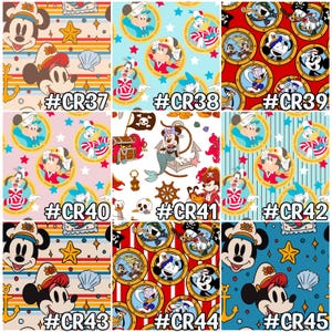 May include: A collection of nine fabric patterns featuring nautical and pirate-themed designs with cartoon characters. The patterns include Mickey Mouse, Donald Duck, and Goofy in sailor and pirate attire, with anchors, stars, and seashells. Each pattern is labeled with a code.