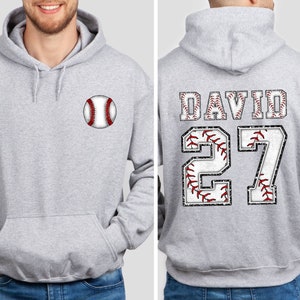 May include: Gray hooded sweatshirt with a baseball graphic on the front and the name "DAVID" and the number "27" on the back, both with a baseball stitch design.