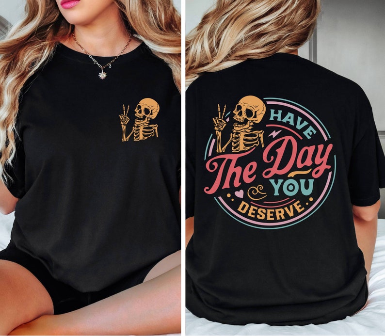 May include: Black t-shirt with a skeleton graphic and the text "Have the Day You Deserve" in a colorful circle.