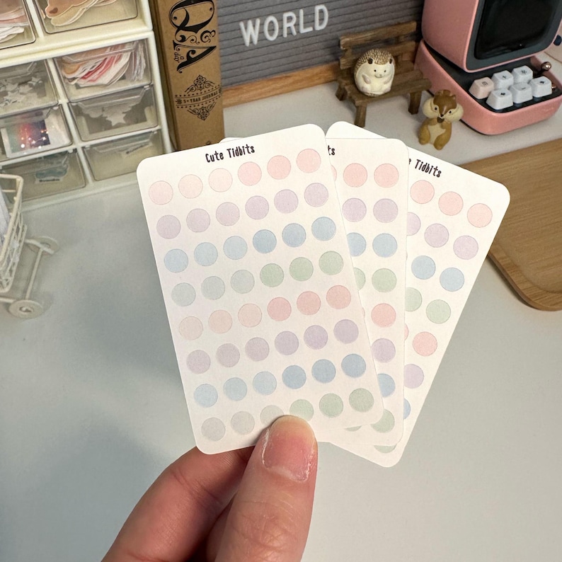 May include: Three sheets of pastel colored dot stickers with the text "Cute Tidbits" on one sheet. The stickers are in shades of blue, green, and pink.