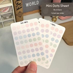 May include: Three rectangular sticker sheets labeled Cute Tidbits, each featuring 48 small circular stickers in pastel shades of pink, purple, blue, and green arranged in a grid pattern on a white background.