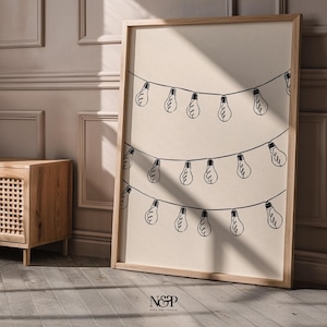 May include: A framed print with a minimalist design of a string of light bulbs hanging from a line. The print is on a beige background and has a wooden frame.