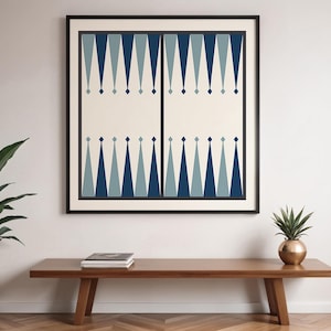 May include: A framed print with a geometric pattern of blue and white triangles. The print is in a black frame and is hanging on a white wall.