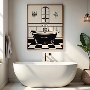 May include: A black and white illustration of a bathtub with a faucet and two chandeliers above it. The illustration is framed and hanging on a white wall in a bathroom with a white freestanding bathtub and a potted plant.