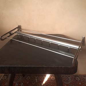 Vintage distressed metal row of hooks and a metal rod shelf combo