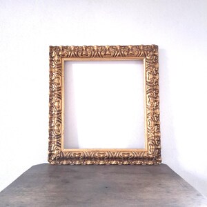 Ornate large wooden golden-colored rectangular picture frame
