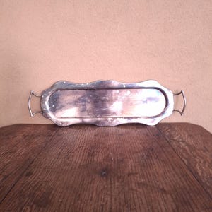Long and narrow sheet metal silver-plated tray with handles