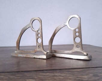A pair of sturdy Art Deco geometrical bronze curtain rod holders