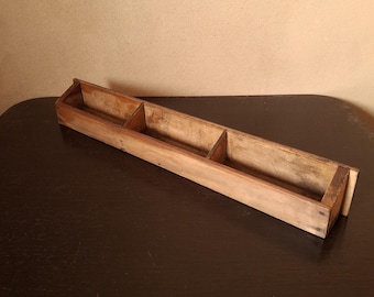 Simple antique wooden tray with three compartments and a rounded bottom