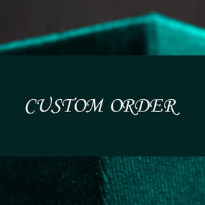 May include: A teal green velvet box with the text "CUSTOM ORDER" printed in white.