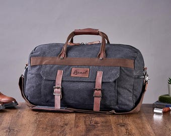 May include: A dark gray canvas duffel bag with brown leather accents and a personalized name tag that reads "Lionel".