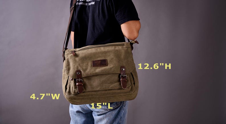 May include: An olive green canvas messenger bag with a brown leather flap closure, two front buckles, and a shoulder strap. The bag measures 15 inches long, 4.7 inches wide, and 12.6 inches high, featuring a rectangular shape and a dark leather patch.