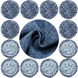 May include: A close-up of ten blue and grey fabric covered buttons with a silver hook and loop closure. The buttons are arranged in a circle around a piece of the same fabric.