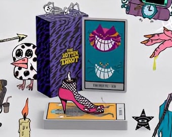 May include: A set of tarot cards with a purple and black box featuring the text "The Rotten Tarot". The box is next to a card with a grinning purple cat on a teal background. The card reads "The Fool No. 0". There are other illustrations around the box and card, including a ghost, a spider web, a hand with dripping yellow liquid, a bird, a candle, and a person in a chair.