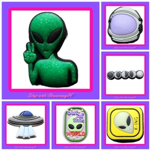 May include: A selection of shoe charms with an alien theme. The charms include a green alien with a peace sign, an astronaut helmet, a UFO, and a charm with the text "Out of this World".