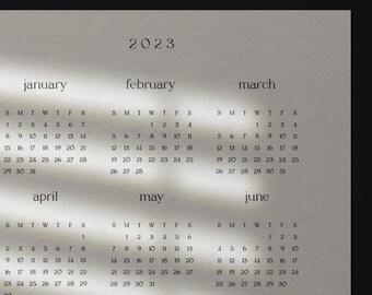 Puede incluir: Calendario minimalista de 2023 con una paleta de colores neutros. El calendario muestra los meses de enero a septiembre, con los días de cada mes dispuestos en formato de cuadrícula. El año "2023" está en la parte superior.