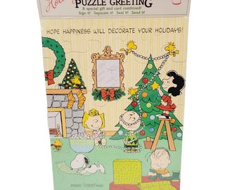 Tarjeta de felicitación navideña vintage de Hallmark con rompecabezas y personajes de Peanuts