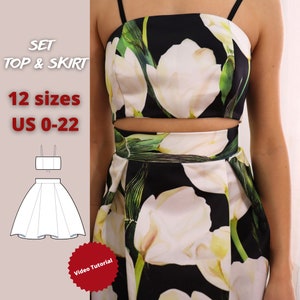 Op de afbeelding: Een naaipatroon voor een crop top en rok set met een bloemenprint. Het patroon omvat 12 maten, van 34 tot 52. De afbeelding toont een witte bloemenprint op een zwarte achtergrond. De tekst "SET TOP & SKIRT" en "12 sizes US 0-22" is zichtbaar in de afbeelding. Een rode ster met de tekst "Video Tutorial" is ook zichtbaar.