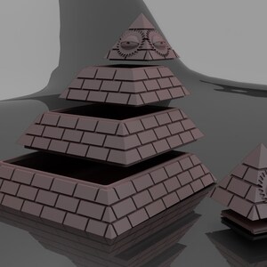 Puede incluir: Modelo de pirámide renderizado en 3D en tonos marrones, con textura de ladrillo. La pirámide está parcialmente desmontada, con capas separadas. También hay una pirámide más pequeña con un diseño de ojo. Incluye el texto "solid object" y "STL".