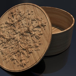 May include: A wooden round box with a lid featuring an intricate floral design. The lid is partially open, revealing the interior of the box. The words "solid object" are visible in the image.