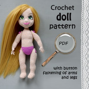 May include: Crochet doll pattern PDF, with button fastening of arms and legs. The doll is 7.09 inches tall and has long blonde hair, green eyes, and a pink swimsuit.