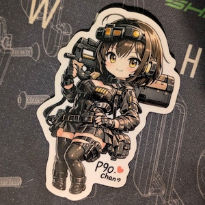 Puede incluir: Una pegatina troquelada con un personaje de estilo anime con equipo táctico, sosteniendo un arma. El personaje tiene cabello castaño y ojos amarillos. La pegatina tiene el texto "P90. chan?" en la esquina inferior derecha.