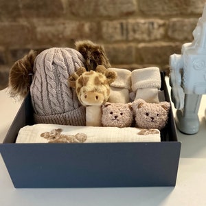 Baby Gift Set. With a Bear Pattern Blanket, Pom Pom Hat, Soft Stick Rattle & a Pair of Bear Socks. Neutral Colourway. Personalise the Box.