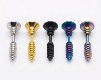 May include: Five screw-shaped earrings in a row, each with a different metallic finish. The colors include silver, gold, black, blue, and a rainbow iridescent effect. The earrings have a flat, round head and a threaded post.