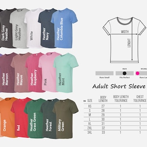 May include: A chart showing the size chart for adult short sleeve t-shirts. The chart shows the body length, body length tolerance, chest tolerance, and chest width for sizes XS to 3XL. The chart also shows the colour options for the t-shirts, which include black, dark grey heather, light grey heather, white, heather navy, heather columbia blue, heather purple, heather maroon, heather mauve, heather raspberry, pink, heather mint, heather peach, orange, red, heather grass green, heather forest, military green, and green.