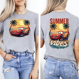 Gray t-shirt with Lightning McQueen in front of sunset and palm trees, back print says “Summer Vibes.” Perfect Pixar Cars beach shirt for vacations and summer fun.