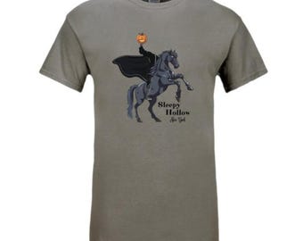 May include: A gray t-shirt with a graphic of the Headless Horseman riding a black horse. The graphic includes the text "Sleepy Hollow, New York".