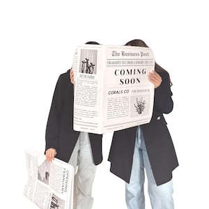 May include: Two people holding newspapers with the headline "The Business Post" and the text "Coming Soon". The newspapers have black and white text and illustrations. The people are wearing black jackets and jeans.